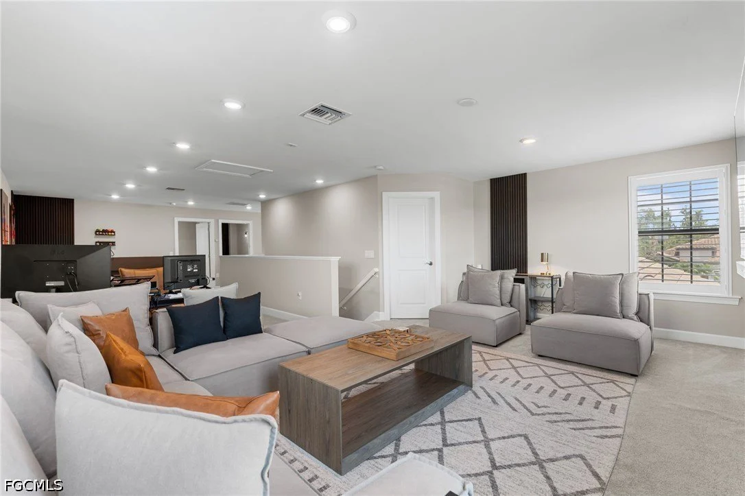 Upstairs loft living area in a two-story home at The Place at Corkscrew