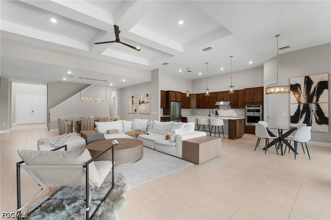 Open-concept great room and kitchen in a home at The Place at Corkscrew, Estero FL